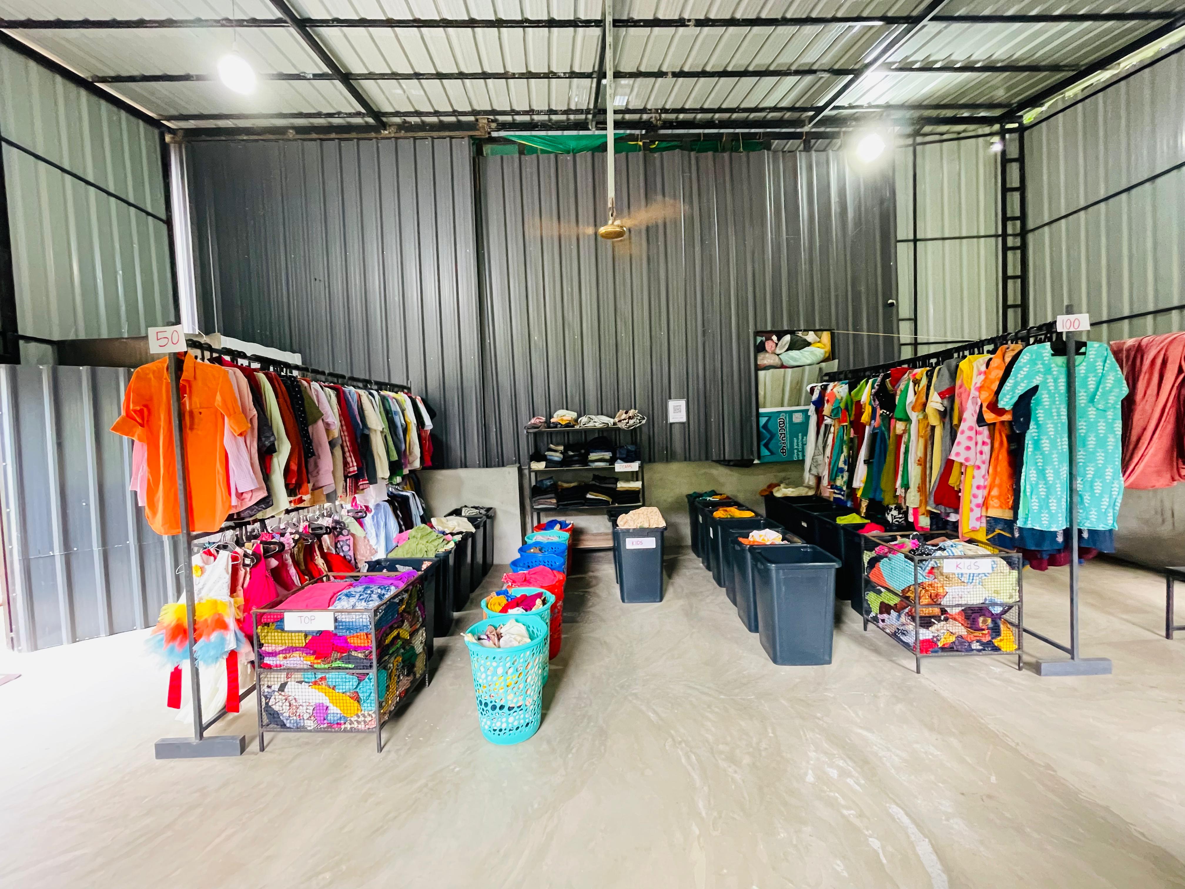 Organized thrift shop with colorful clothing racks showing textile reuse and community distribution